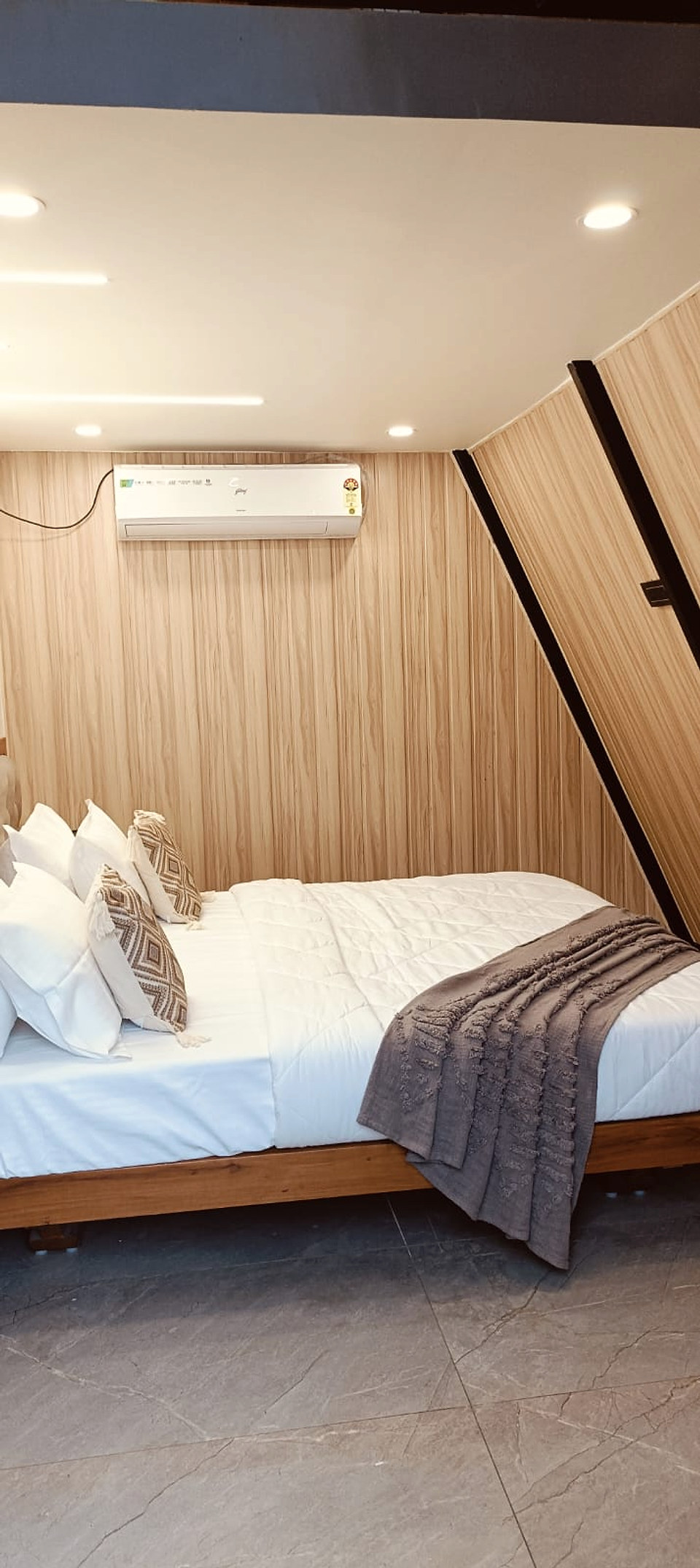 Vertical view of bedroom with warm timber walls