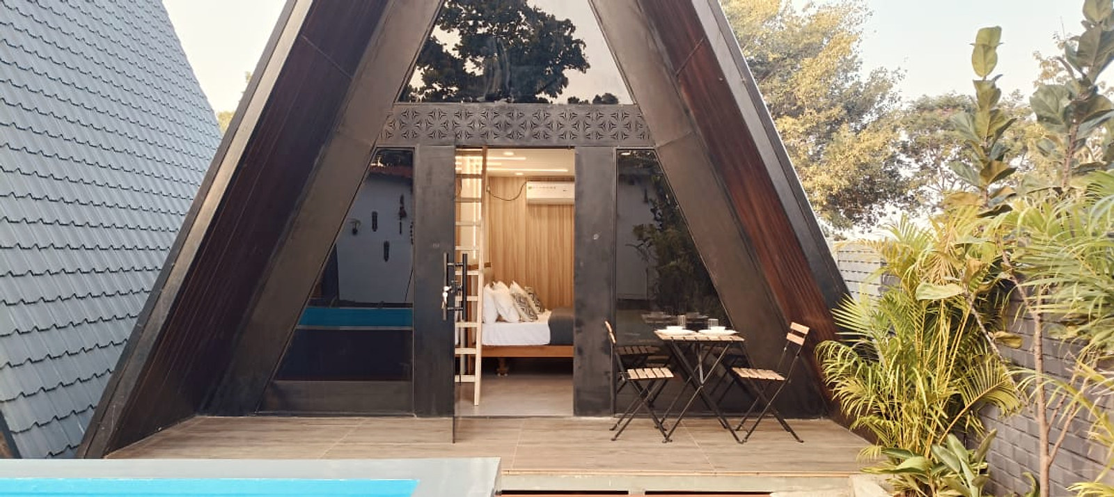 Glass-fronted A-frame cottage with a private outdoor dining deck