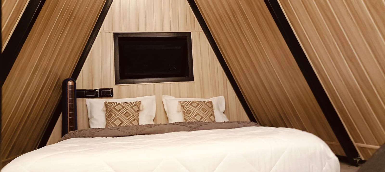 Upper sleeping loft framed by A-frame walls